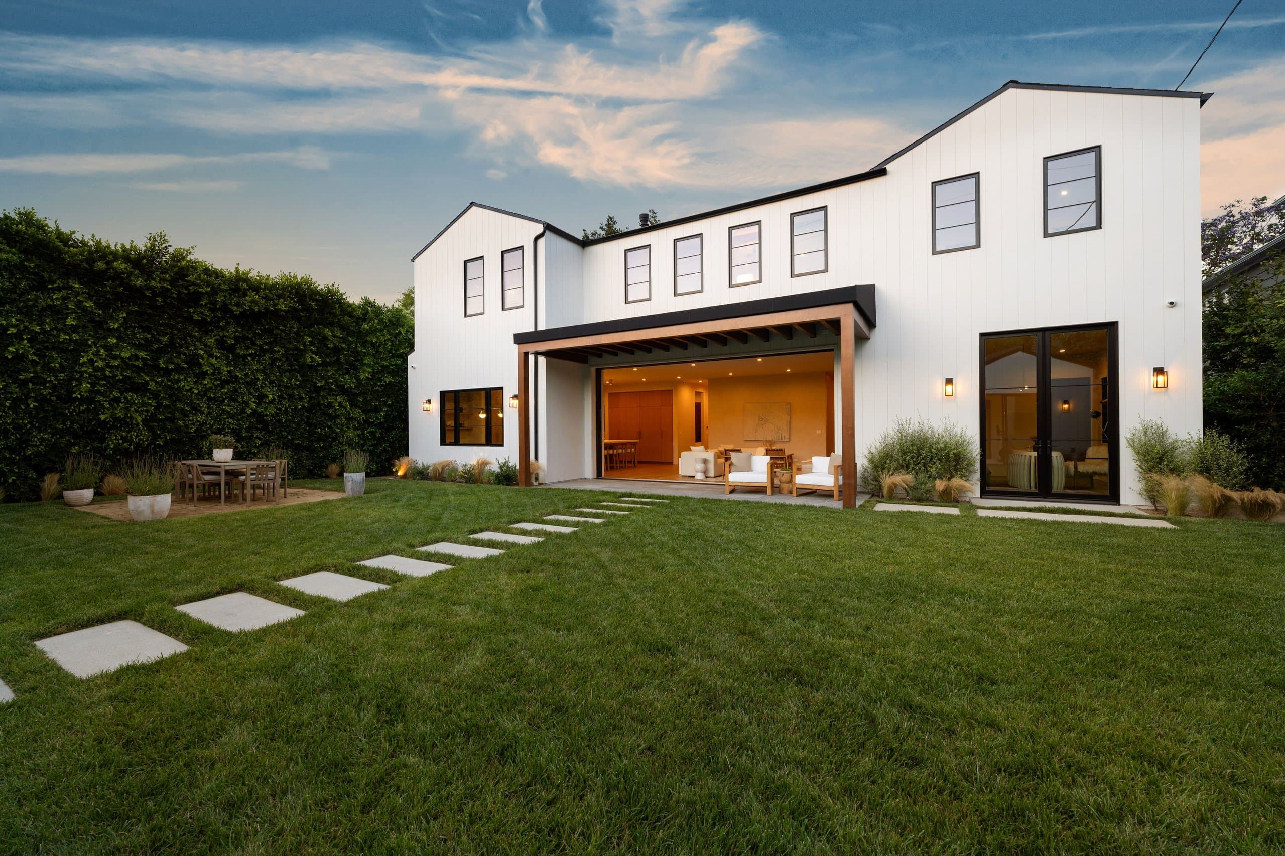 Outdoor dining area at dusk with artificial turf — inspiration for what's possible
