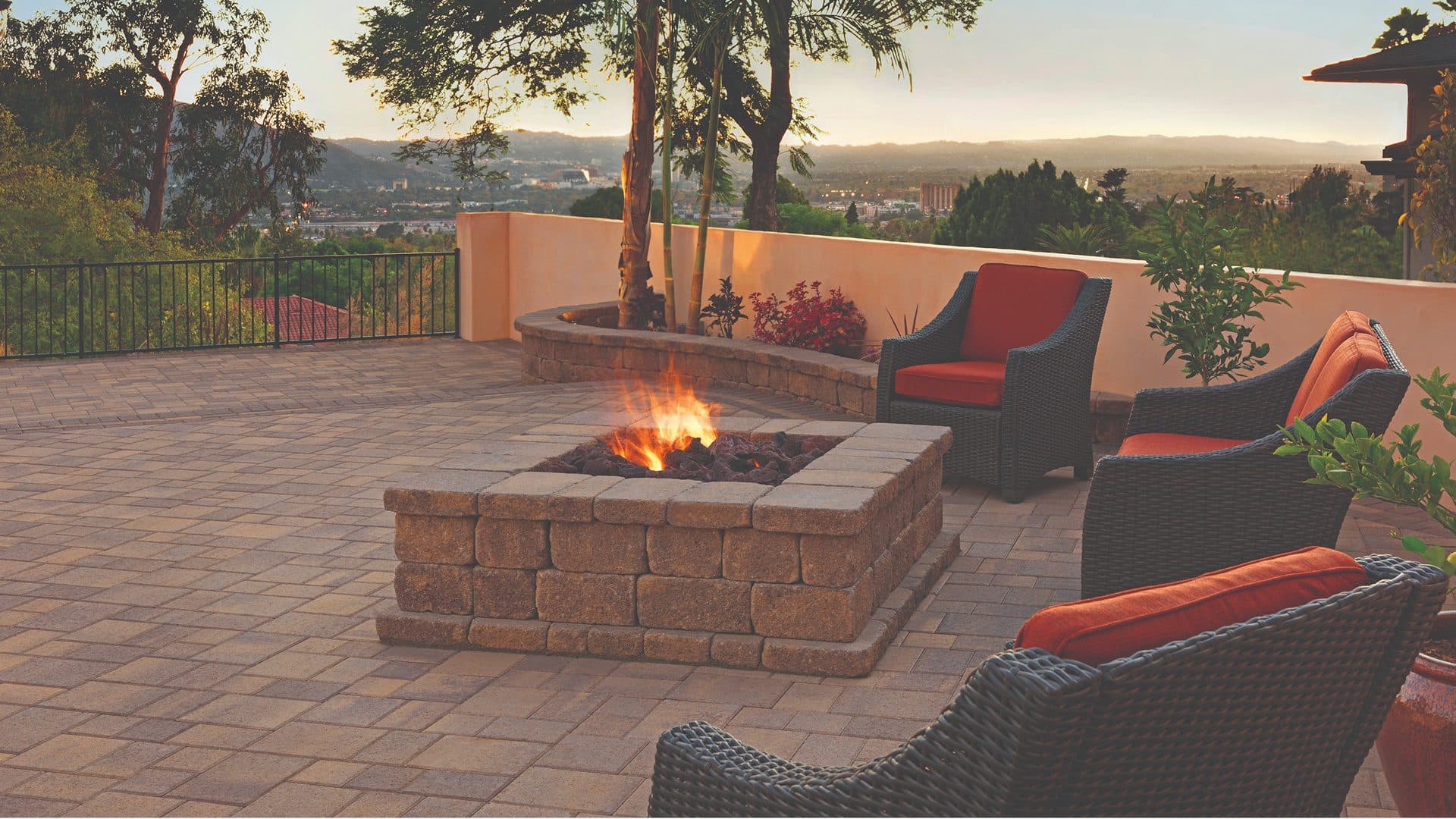 Block fire pit on a paver overlook patio at dusk with valley views