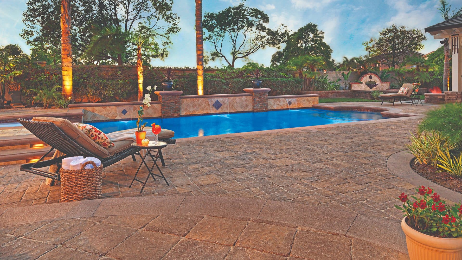 Resort pool deck in tumbled estate cobble pavers at sunset