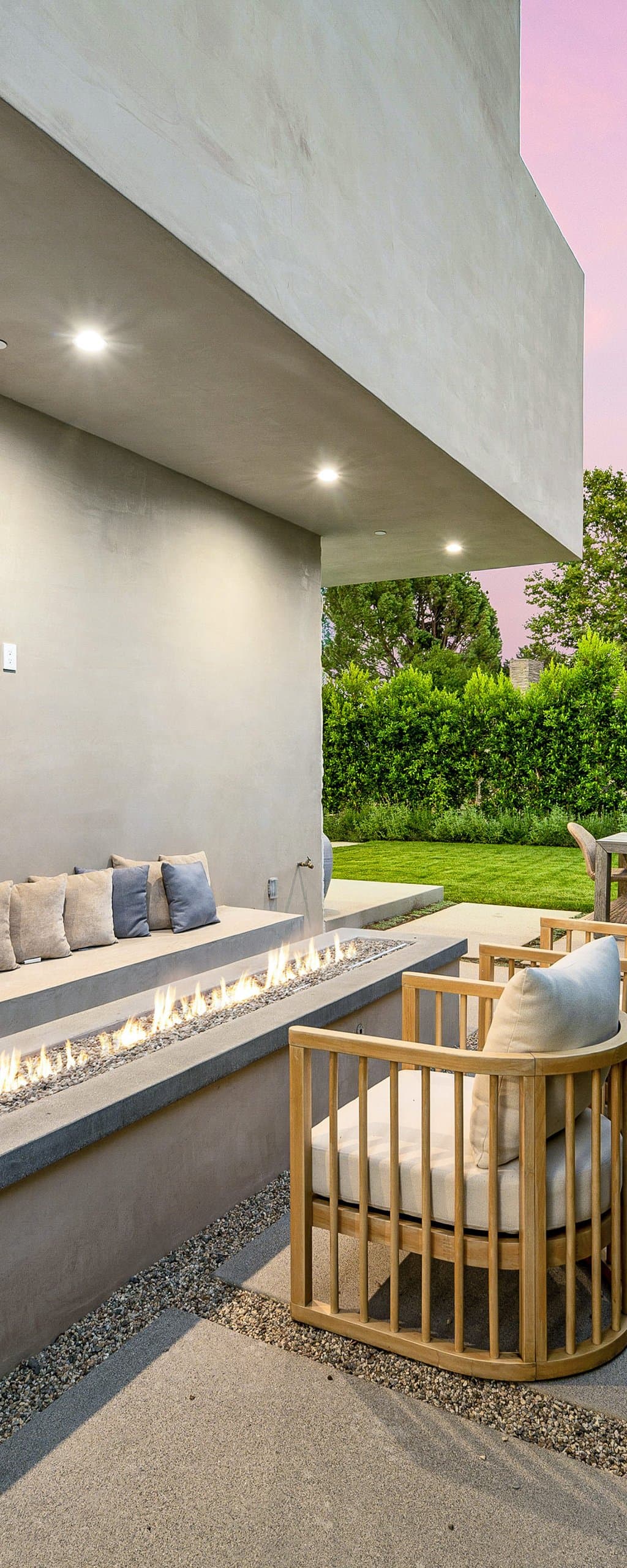 Pergola lounge, concrete path, gravel, and white planting in one cohesive material palette