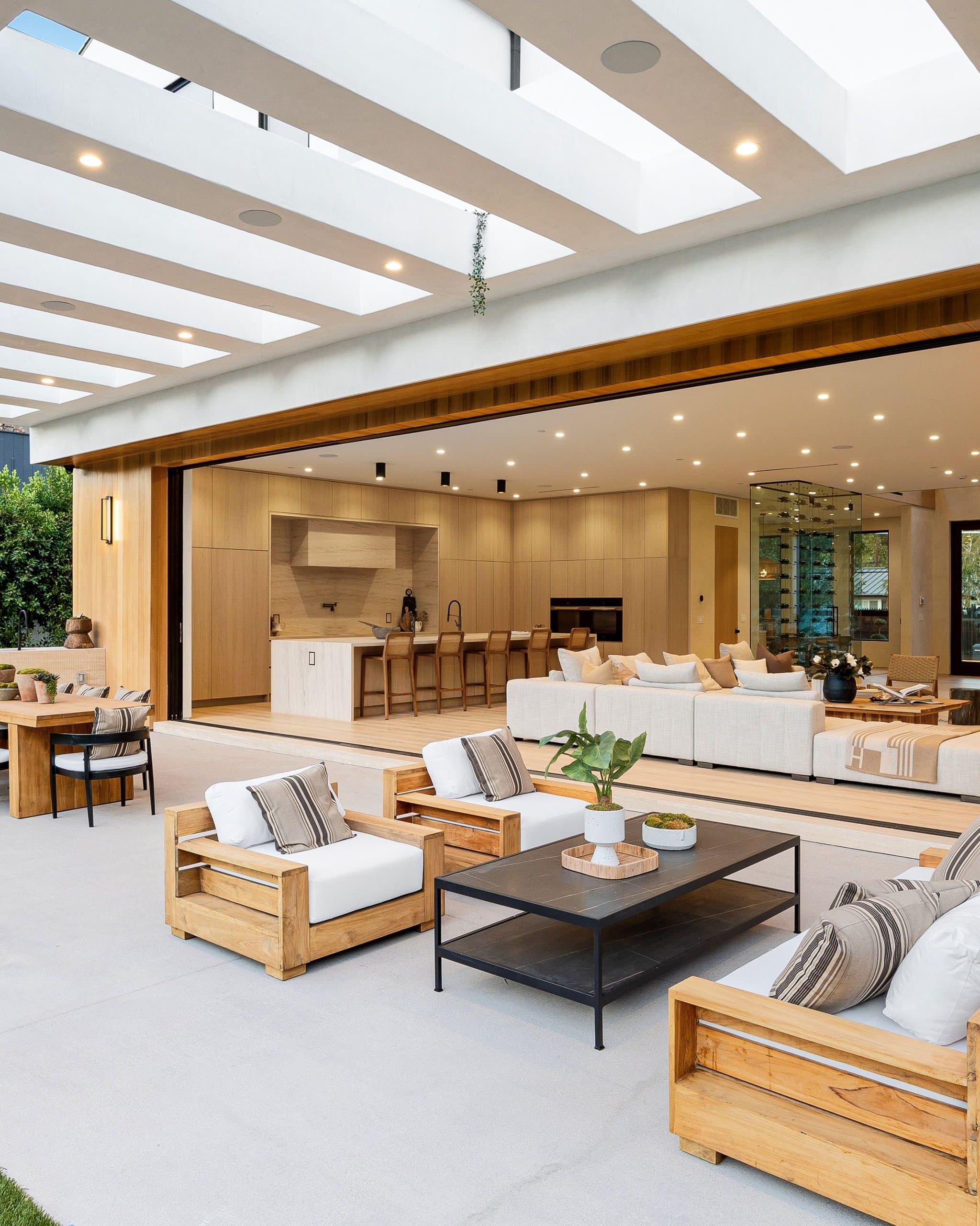 Smooth-trowel concrete patio with outdoor dining table and built-in grill