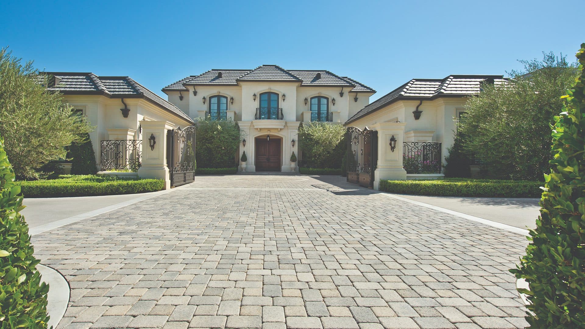 French chateau estate with a broad cobble paver motor court