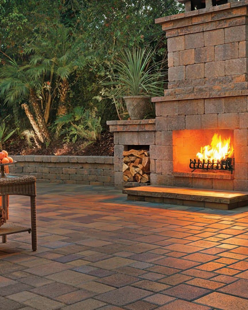 Spanish courtyard with blended pavers, stone archway, and outdoor fireplace