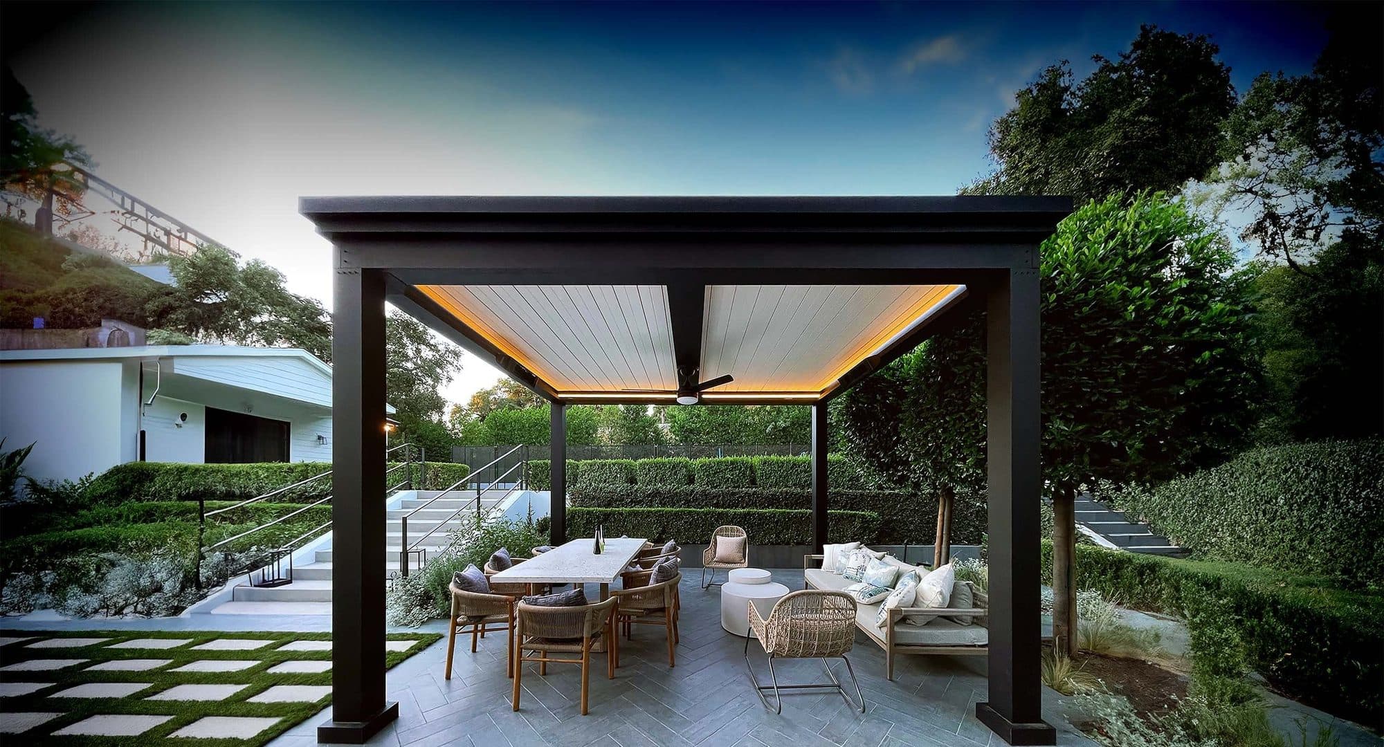 Black pergola with warm LED edge lighting over an outdoor dining table