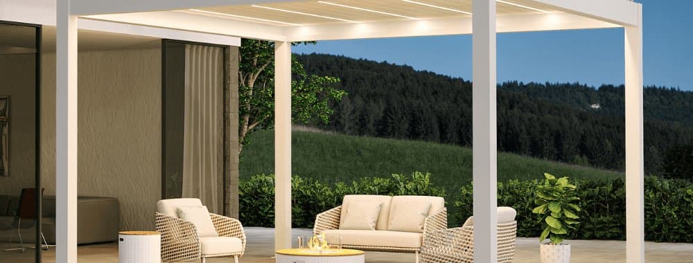 White free-standing pergola with integrated lighting over patio seating